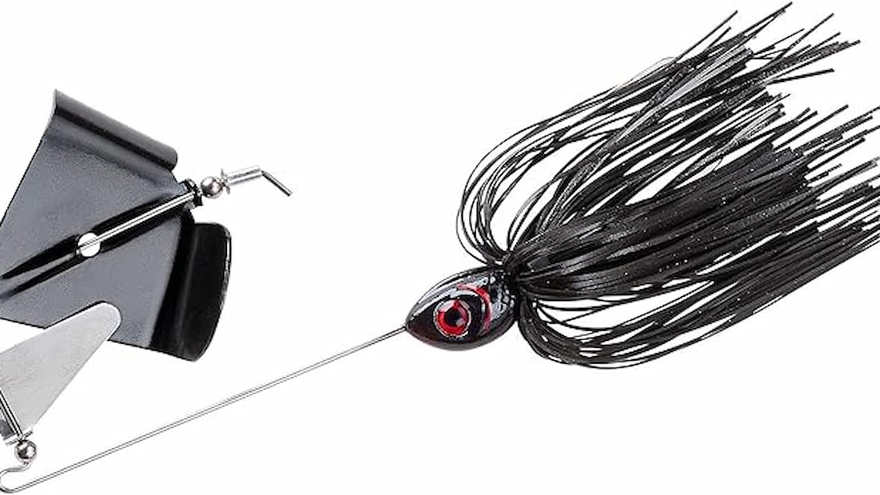 Black buzzbait fishing lure with skirted tail and red-eye head, metal propeller blade in front