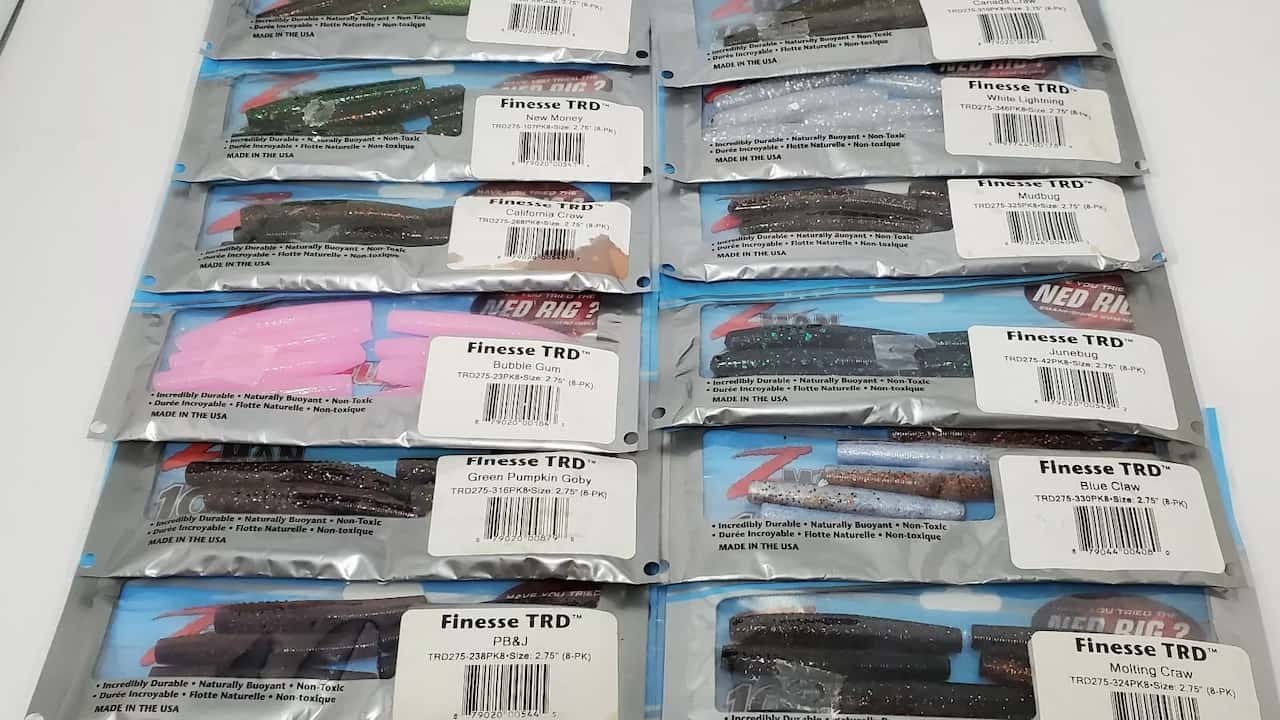 Assorted packs of Z-Man Finesse TRD soft plastic fishing baits in various colors laid out in three rows