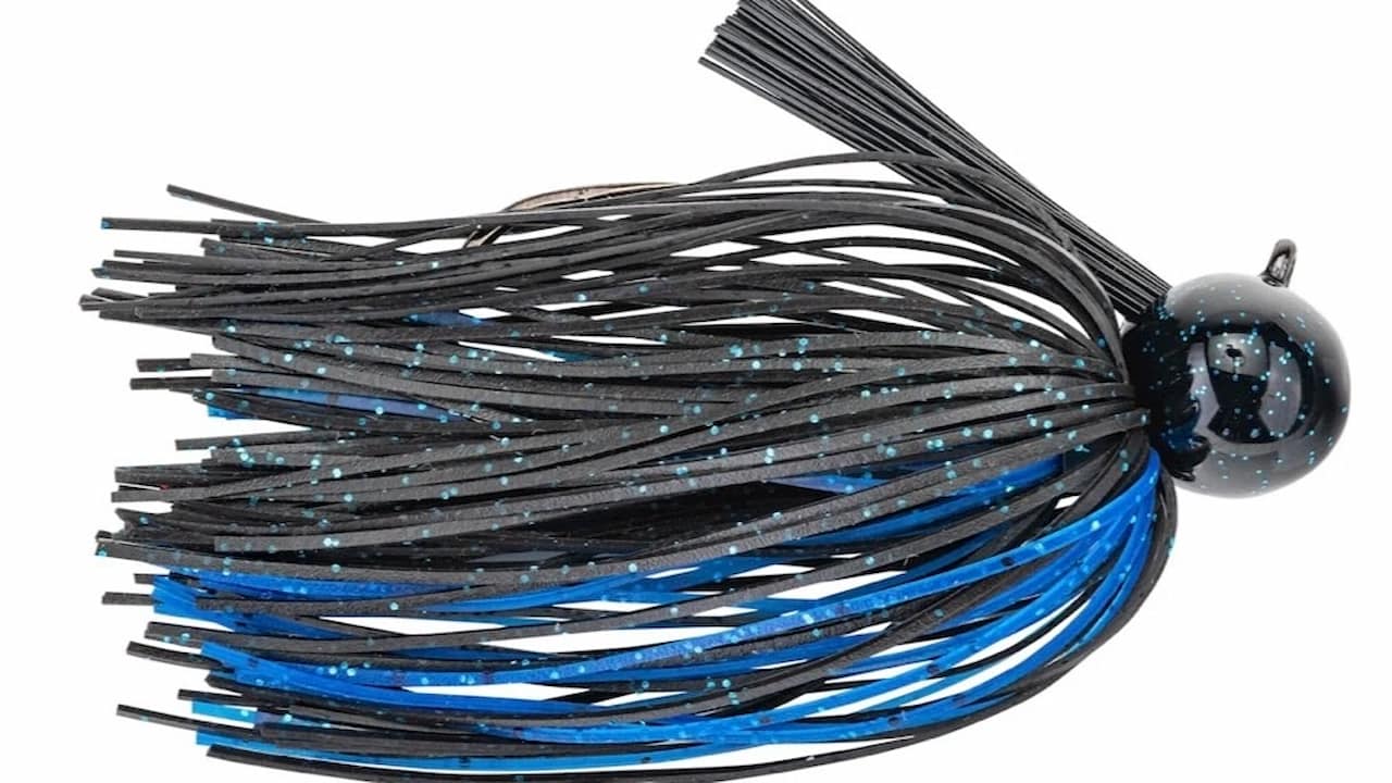 Black and blue skirted jig fishing lure with a round head and weed guard