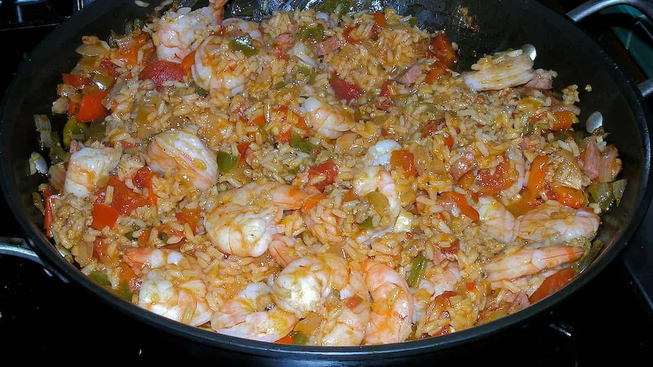 Pan of jambalaya with shrimp, rice, chopped vegetables, and sausage